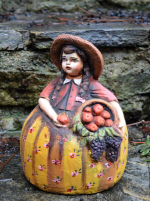 Handmade ceramic girl with basket of apples