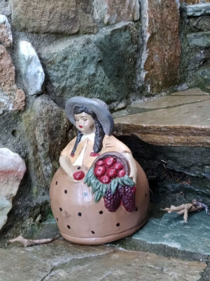 Handmade ceramic girl with basket of apples