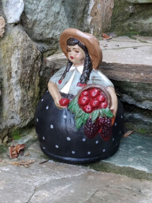 Handmade ceramic girl with basket of apples