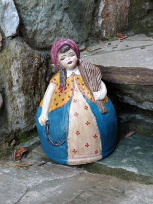 Handmade ceramic girl with alstroemeria